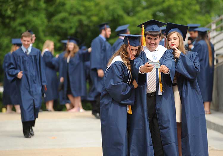 STAFF+PHOTO+ANDY+SHUPE+-+Rogers+Heritage+graduating+seniors+Bailey+Black%2C+Jacob+Kent+and+Kaleigh+Begneaud+take+a+photograph+before+the+start+of+commencement+exercises+Friday%2C+May+16%2C+2014%2C+at+Bud+Walton+Arena+in+Fayetteville.+The+school+graduated+505+students.+Visit+photos.nwaonline.com+to+see+more+photos+from+the+evening.
