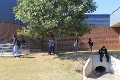 Students stand socially distanced outside for a mask break. 