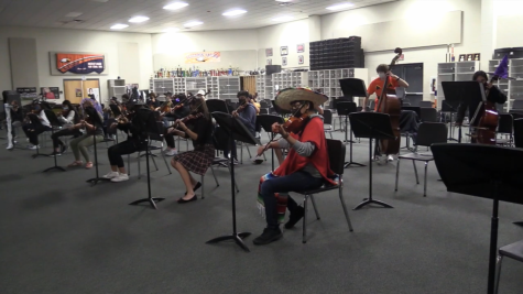Orchestra students perform while socially distanced.