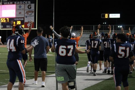 On the sidelines, War Eagles celebrate a touchdown. 