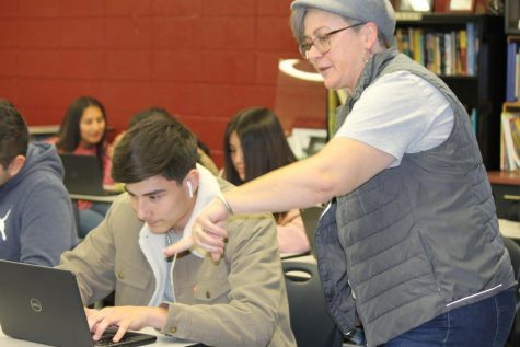 Marsha Walkers directs William Moore (10) to notice something on his Chromebook. 