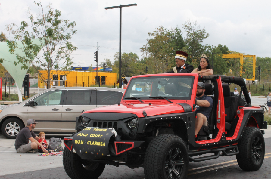 The HHS King and Queen ride in a Jeep through Downtown Rogers for the 2021 Homecoming Parade. 