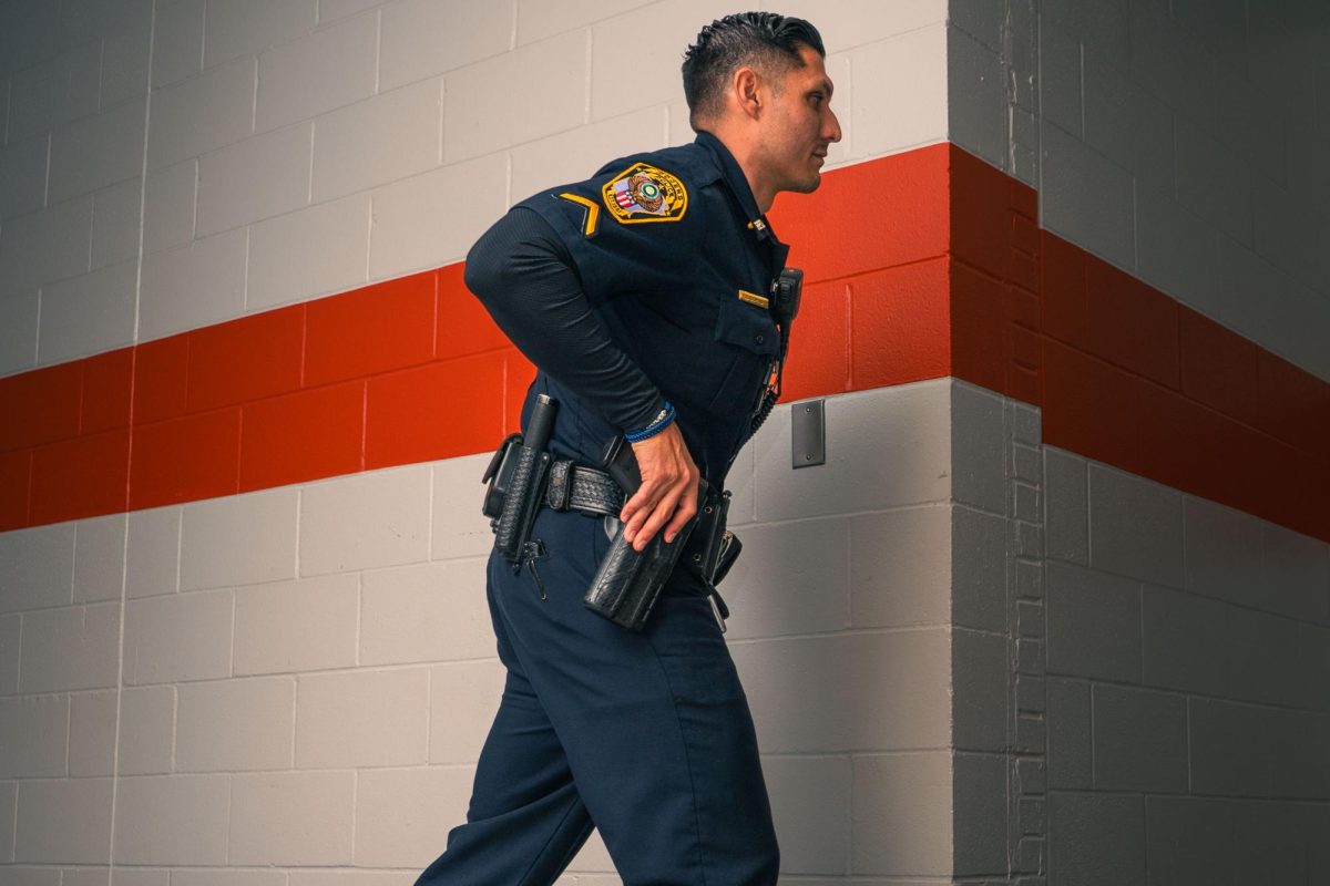 School Resource Officer (SRO) Jeffery Ochoa demonstrates patrolling the halls daily to ensure students' safety. 