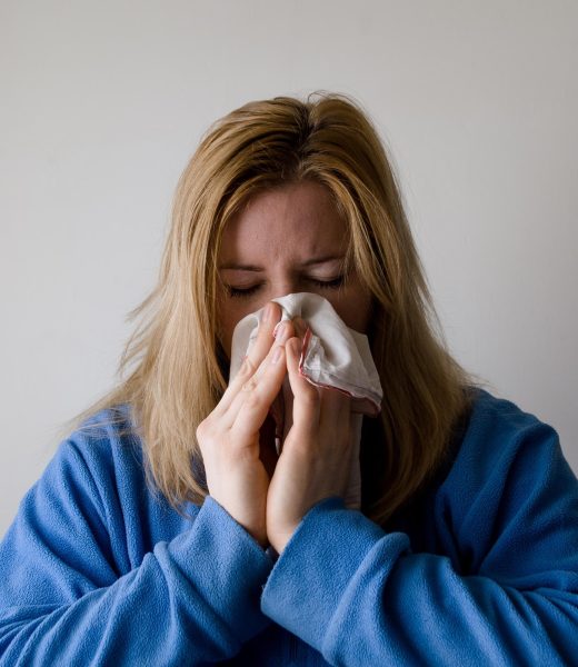 A person struggling with a cold attempts to relieve drainage.