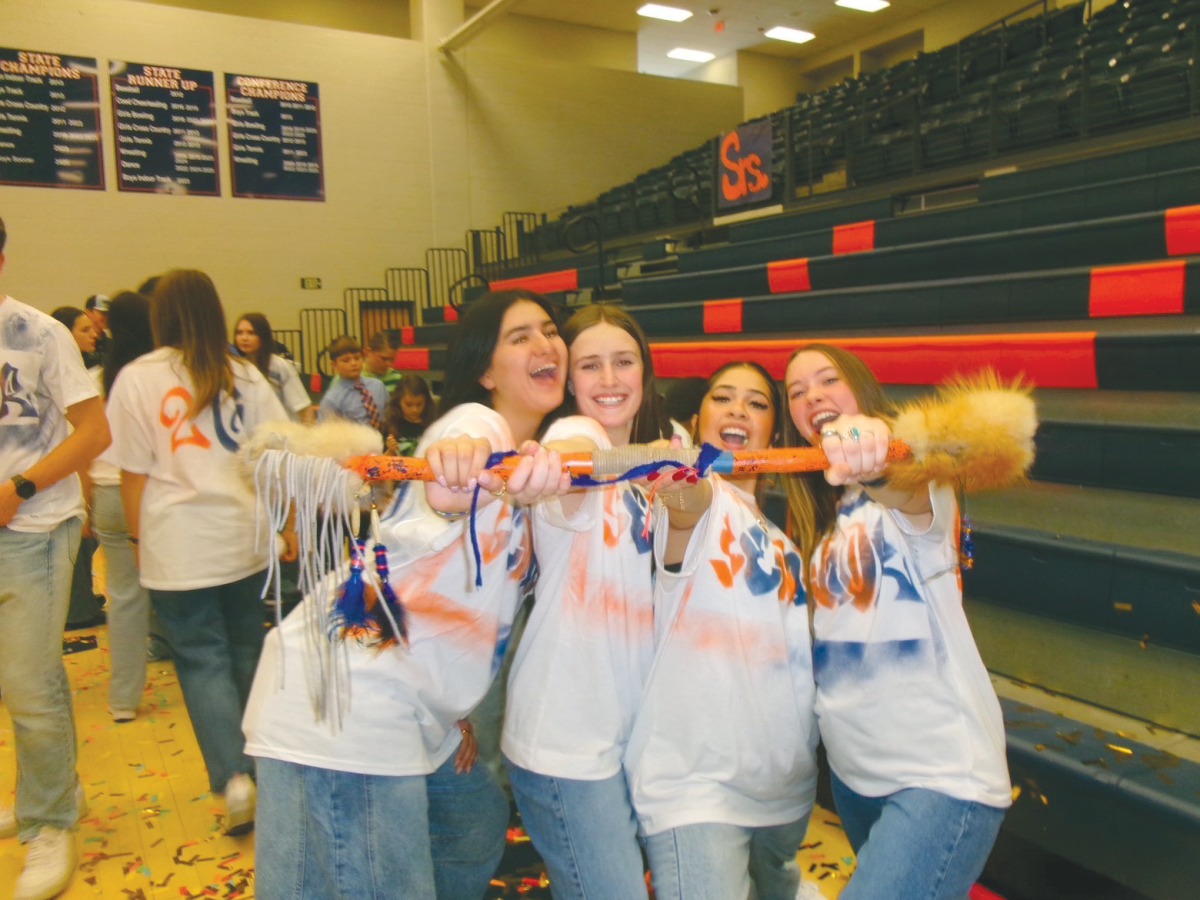 A group of seniors posing with the spirit stick after winning the Colors Day
dance battle.